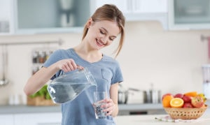 young woman pouring water